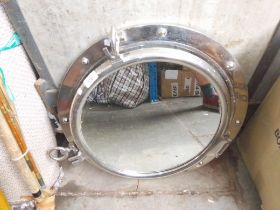 A metal porthole mirror by Next and two copper warming pans.