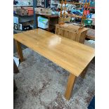 A modern light oak dining table.