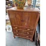 A 1930s walnut tallboy.