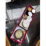 A box of pocket watches movements and yellow metal items.