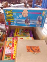 A box of vintage toys including Kerplunk.