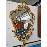 A gilt framed mirror.