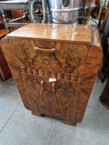 A 1930s Art Deco walnut cocktail cabinet.