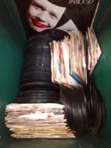A box of 7" singles and 3 LP vinyl records.