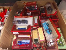 A box of assorted Models of Yesteryear die-cast model vehicles.