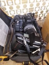 A Yukon spotting scope, a Fuji Finepix digital camera in bag, an a Nikon 35mm F90X, and a boxed