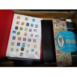 A box of UK and world stamp albums.