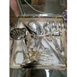A box of assorted silver plated ware.
