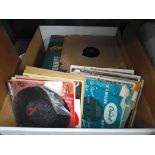 A box containing 45rpm records and some LPs