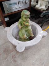 A circular concrete planter and a garden cherub figure - as found