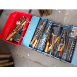 A plastic red tool box of assorted tools and a metal toolbox containing assorted tools