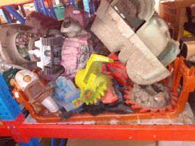 A box of He Man toys.