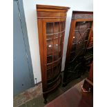 An Edwardian glazed mahogany corner cabinet on ball and claw feet.