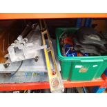 A box of assorted tools & a table saw.