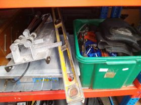 A box of assorted tools & a table saw.