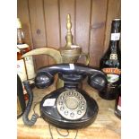 A brass arabian coffee pot and a vintage telephone