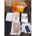 A bag of assorted stamp albums.