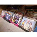 Four boxes of vinyl LP records, various genres including Bay City Rollers signed by all band