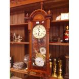 A PR 31 day wall clock with pendulum and key and 2 barometers, one brass case, one wood.