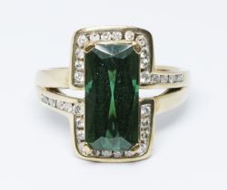A green tourmaline and diamond ring, the central rectangular cut stone weighing approx. 4.50cts, set
