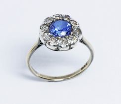 A synthetic sapphire and diamond ring, the cluster measuring approx. 11.9mm in diameter, band marked