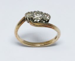 A three stone diamond ring, yellow band unmarked, gross wt. 2.5g, size J. Condition - general wear.