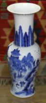 A Chinese porcelain baluster vase with flared rim, decorated in underglaze blue with village