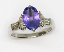A tanzanite and diamond ring, the oval cut tanzanite weighing approx. 2.30cts, marquis and