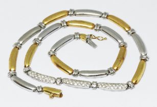An 18ct yellow and white gold diamond necklace, elongated bean shaped links with the three central