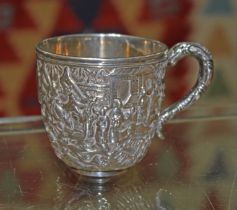 A Chinese export silver teacup, decorated all over with a village scene, Wang Hing & Co, height 6.