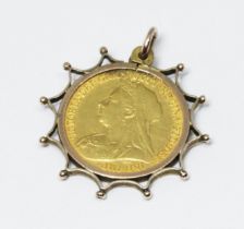 A Victoria 1899 half sovereign mounted, unmarked, gross wt. 5.4g.