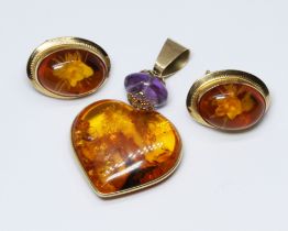 A suite of amber jewellery, the earrings marked '750', the pendant indistinctly marked,