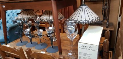 Decorative items comprising three Tiffany style lamps, a set of four metal and glass tea light