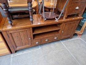 A hardwood TV stand and matching chest of drawers.