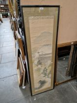 A Japanese painting, buildings in a mountain landscape, framed and glazed, 49.5cm x 153cm.