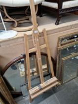 A full size artist's adjustable easel together with a set of brushes.