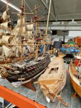 Two wooden model boats; one with built in stand and one other as found.