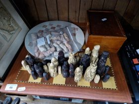 Two chess sets, one soapstone and one wooden, together with another set of pieces.