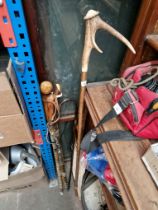A bundle of walking sticks, and a vintage umbrella, one stick with a silver tipped handle