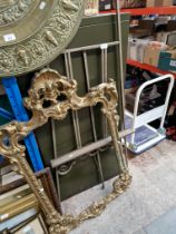 A vintage gilt frame and a metal easel.