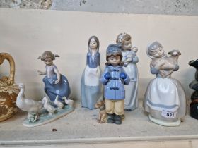 A Lladro figurine (5503) and four Nao figurines.