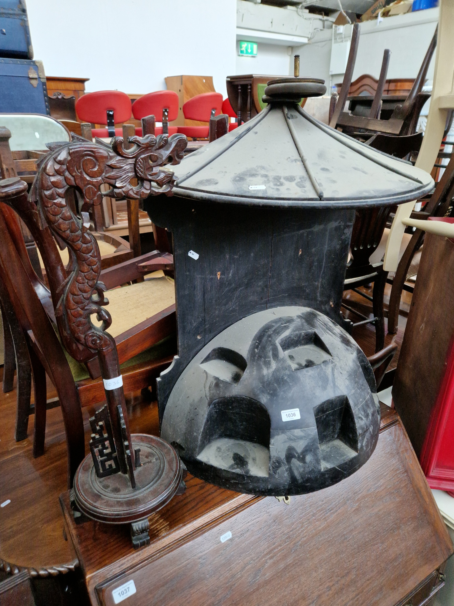 An Eastern display stand modelled as a pagoda and a carved wood lamp base modelled as a dragon.