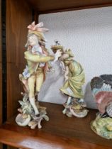 A pair of continental porcelain figures, Meissen style crossed swords mark to base., height 29cm.