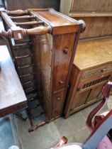 A Victorian rosewood Canterbury adapted for use as a window seat.