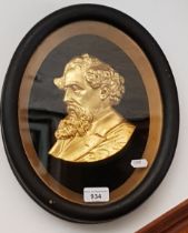 A late 19th/early 20th century framed gilt metal portrait of Charles Dickens, 27cm x 34cm overall.