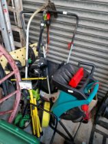 A quantity of garden machinery including Karcher washer, shredder, petrol strimmer, workbench,