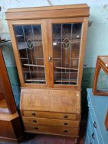 An early 20th century oak and leaded glass bureau bookcase.