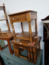 An Ercol elm nest of tables together with an Ercol side table with drawer.
