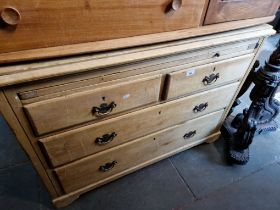 An Edwardian pine chest of drawers with slide out brushing slide.