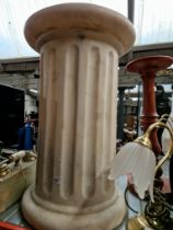 A simulated white marble column plinth.